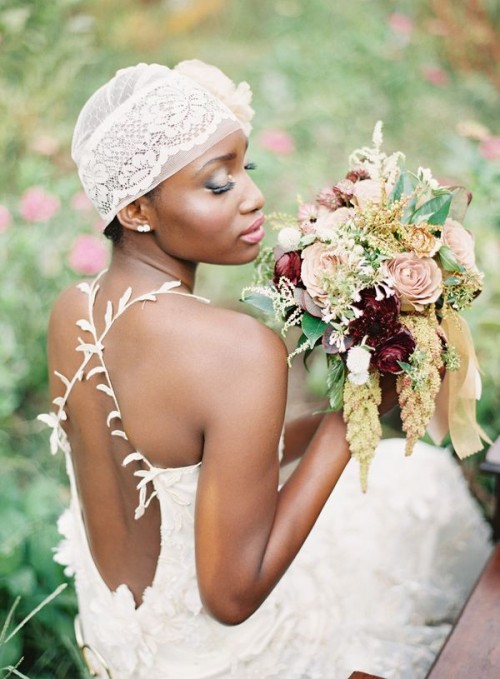 a lace cap veil with a large fabric flower on one side is a creative and free-spirited idea