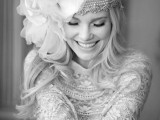 a sparkling rhinestone headpiece with an oversized fabric flower on one side for a glam boho bride