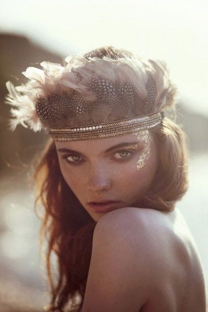 a sequin and pearl bridal headpiece with lots of feathers reminds of Native American headpieces