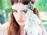 a lace and rhinestone headpiece with a fabric bow with a pearl and long feathers down for a wild boho look