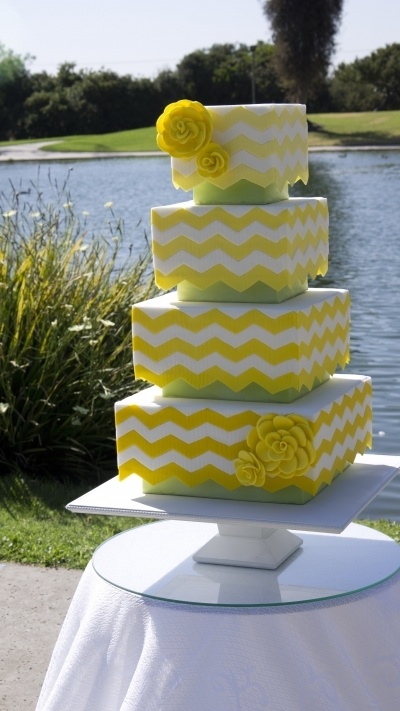 a yellow and white square chevron wedding cake with yellow sugar blooms is a bold and cool idea for a spring or summer wedding