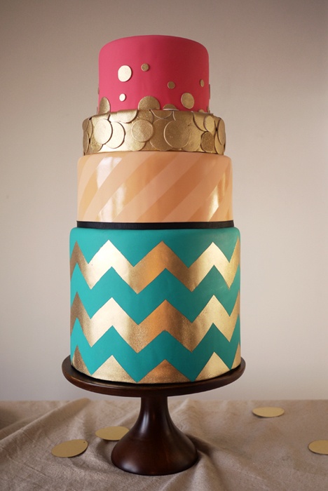a colorful wedding cake with a fuchsia, gold polka dot, striped blush and turquoise and gold chevron tier is a fantastic idea for a modern wedding