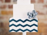 a square navy and white wedding cake accented with a succulent is a stylish solution for a mid-century modern wedding and it looks chic and cool