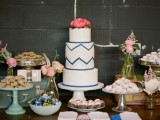 a white navy and blush chevron wedding cake with bold coral blooms on top is ideal for a mid-century modern or boho wedding