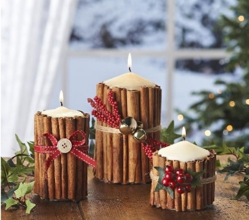candles covered with cinnamon sticks, with faux berries, ribbons and mini bells is a very cozy and rustic idea