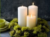 a moss wreath with candles is a simple and all-natural wedding centerpiece suitable for winter or Christmas
