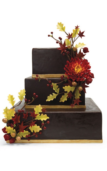 a chocolate square wedding cake decorated with fall blooms and leaves is a very stylish and bold idea