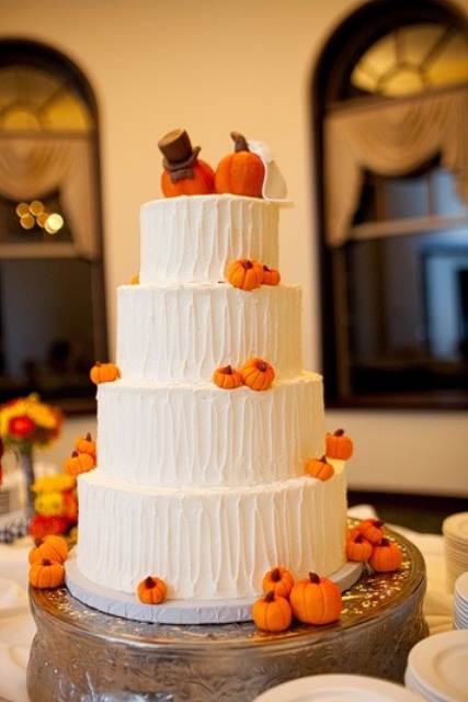 a textural white buttercream wedding cake with sugar pumpkins is a fun and whimsical idea