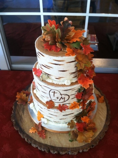 a birch bark wedding cake decorated with sugar fall leaves and pumpkins is ideal for a rustic wedding