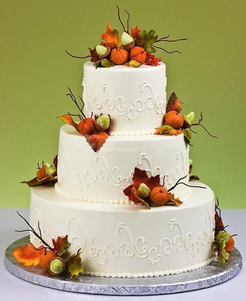 a white patterned wedding cake decorated with sugar pumpkins, leaves and twigs always works for fall weddings