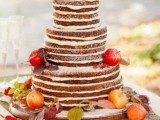 a naked chocolate wedding cake topped with foliage and fresh apples looks cute and tastes delicious