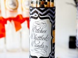 long and thin cookies in a bottle styled as witches’ witted wands are unique and bold Halloween wedding favors