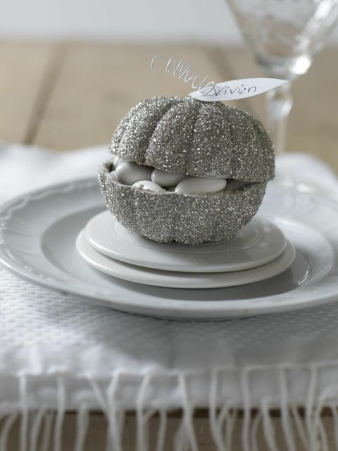 a silver glitter pumpkin with white candies is a lovely and cool Halloween wedding favor to rock