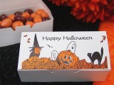 a Halloween box with brown and orange candies is a cool wedding favor idea to rock