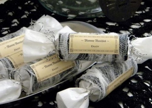 packs of candies in cheesecloth that imitates spiderweb are delicious and cool-looking Halloween wedding favors