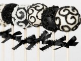 black and white patterned glitter cake pops with bows are elegant and glam Halloween wedding favors