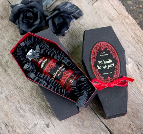 a black and red coffin box with a mini alcohol bottle is a crowd-pleasing wedding favor for adults