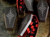 painted coffin boxes with black and red candies are cool themed Halloween wedding favors to rock