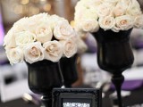 black vases with lush white roses for an elegant and formal centerpiece