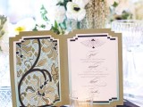a black and white place setting and a menu in black, white and gold