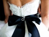 accent your white wedding dress with a black silk sash and a bow on the back for a touch of drama