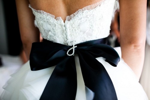 accent your white wedding dress with a black silk sash and a bow on the back for a touch of drama