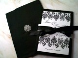 black and white wedding stationery with patterns, bows and a brooch looks very elegant