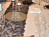 a white tablecloth, a black runner, black and white candles, black fans