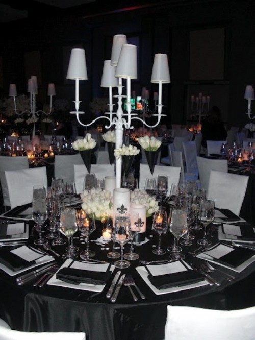 a black and white tablescape and a white table lamp with hanging black cones with blooms