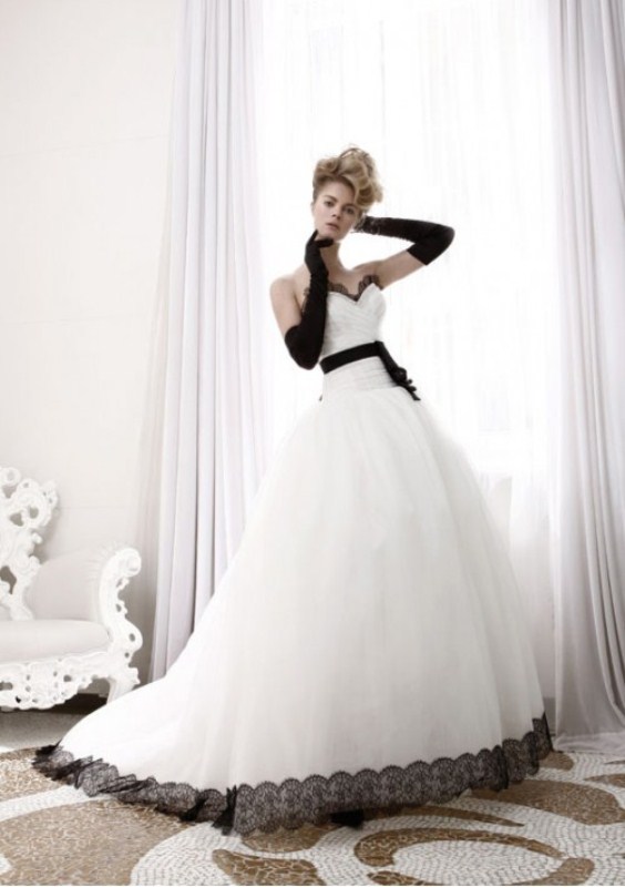 A princess style wedding gown with black gloves and a black sash