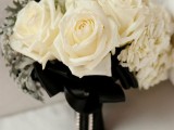 a white rose wedding bouquet with pale millet and black bows