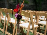 wedding aisle decor with bright and dark fall flowers in a vase
