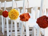 bright floral pomanders to decorate the aisle is a fun and bold idea for aisle decor