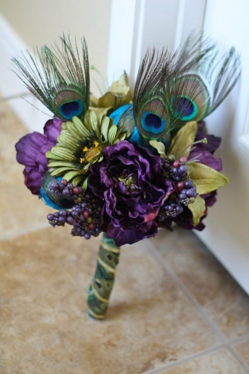 a bold purple and green wedding bouquet with peacock feathers incorporated