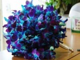 a purple orchid wedding bouquet with peacock feathers is a bright idea with a colorful statement