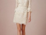 a short lace 70s inspired wedding dress with a high neckline, short bell sleeves for a hippie-loving bride