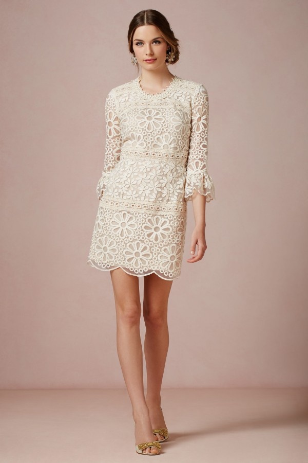 A short lace 70s inspired wedding dress with a high neckline, short bell sleeves for a hippie loving bride