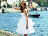 a strapless A-line ruffle wedding dress and white peep toe shoes for a playful and modern look
