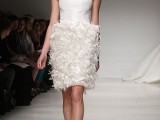 a short wedding dress with a sleeveless plain bodice with a high neckline and a feather skirt is very glam