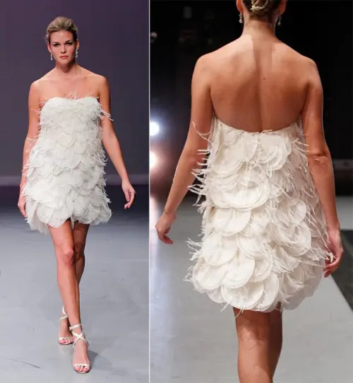 a strapless scallop open back and feather wedding dress paired with strappy heels for a catchy and out of the box look