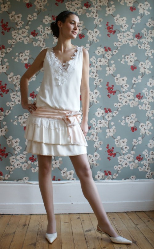 a vintage-inspired wedding dress - a plain with lace one, with a ruffle skirt, a lace applique neckline and a pink sash