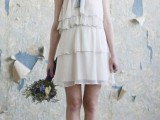 a short A-line layered wedding dress with a halter neckline, a blue bow a nd peep toe shoes for a vintage-inspired outfit