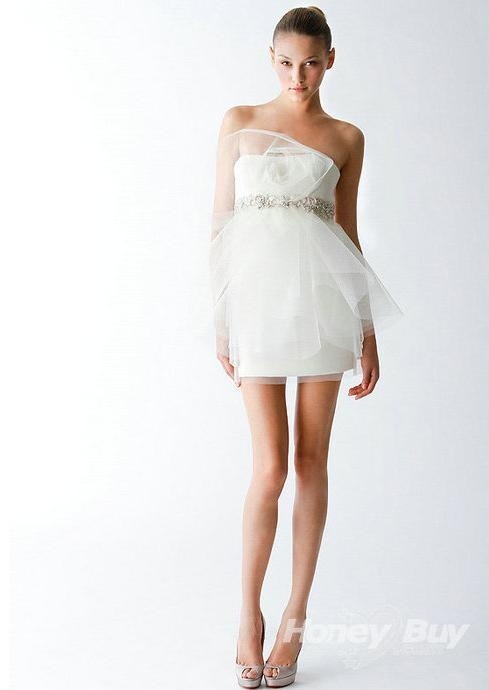 a breezy strapless mini wedding dress with lots of tulle on top and an embellished sash for a modern romantic bride