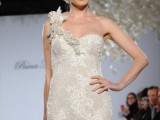 an ivory lace short wedding dress with a floral strap on one shoulder and fabric blooms in the hairstyle