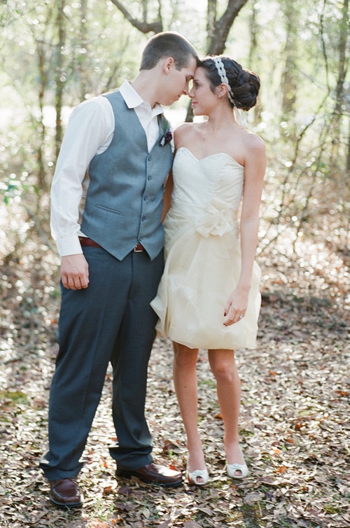 a short ivory A-line wedding dress with a fabric flower and a full skirt for a fresh take on a vintage wedding dress
