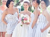 beautiful light grey and white striped knee bridesmaid dresses with layered bodices are perfect for a beach wedding