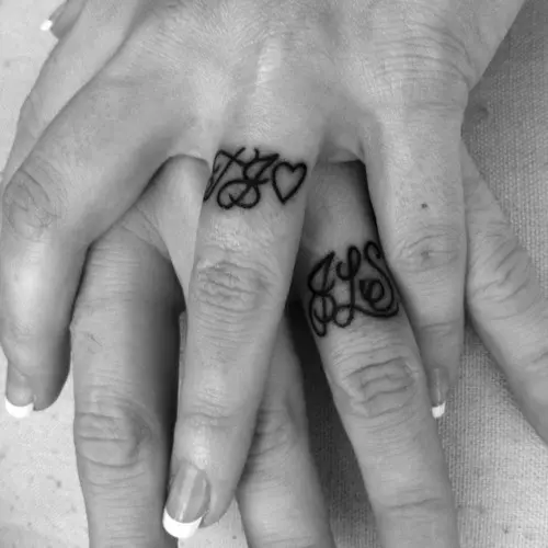 Monograms and hearts are a very romantic idea of tattoo wedding bands