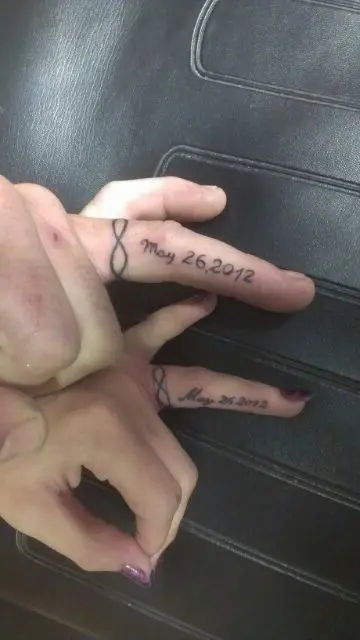 Infinity ring tattoos with a wedding date done on the side of your fingers