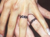 Matching wedding ring tattoos done with a creative pattern that you two like
