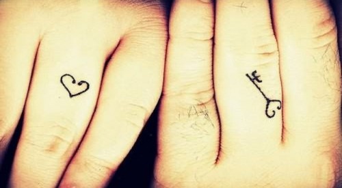 A key and a heart tattoos for a husband and a wife